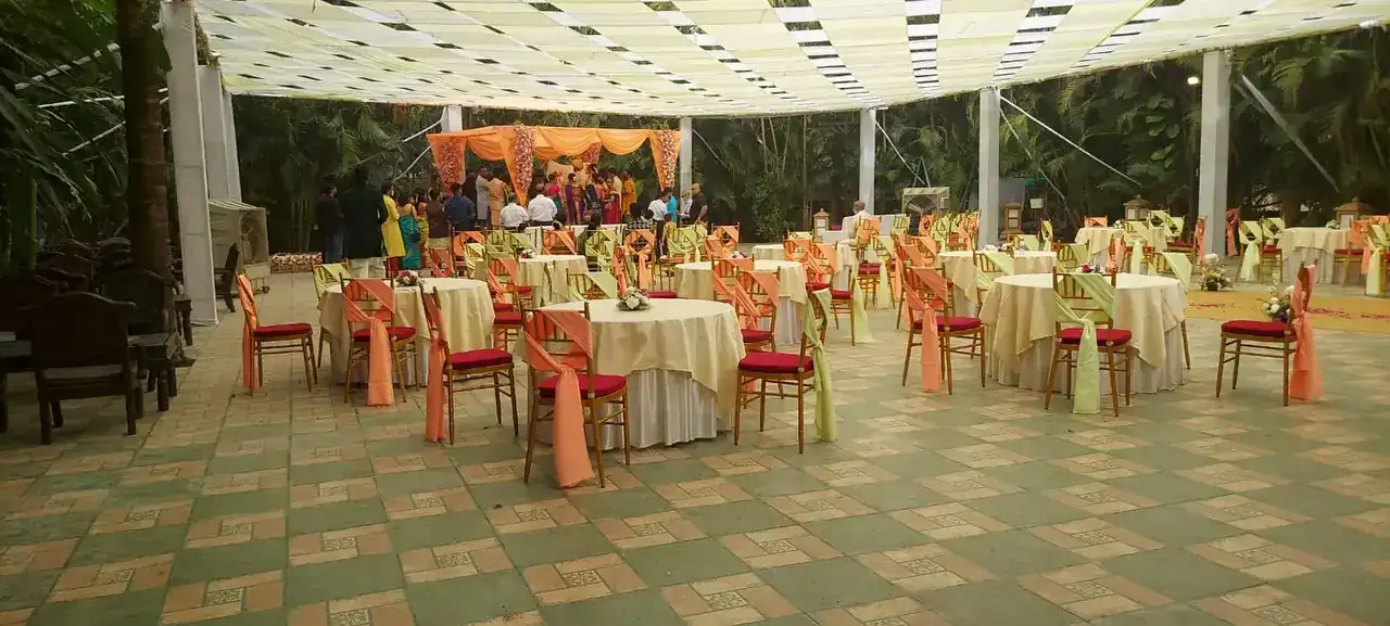 Banquet tables dressed in peach linen under the white canopy at Exotica