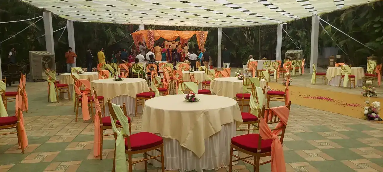 Round banquet tables set under the canopy at Exotica