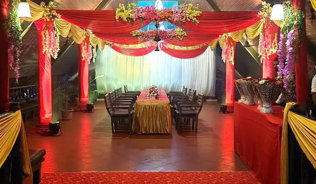 Indoor banquet hall decorated with red and gold drapes for a wedding at Exotica