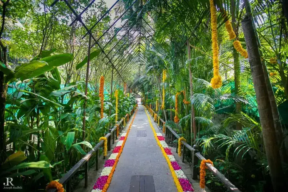 Flower-lined walkway through the tropical greenery at Exotica