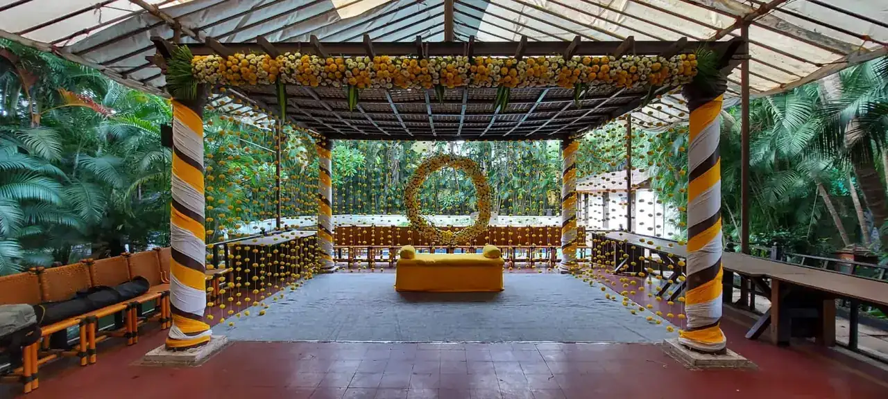 Function pavilion with yellow and orange draped columns at Exotica