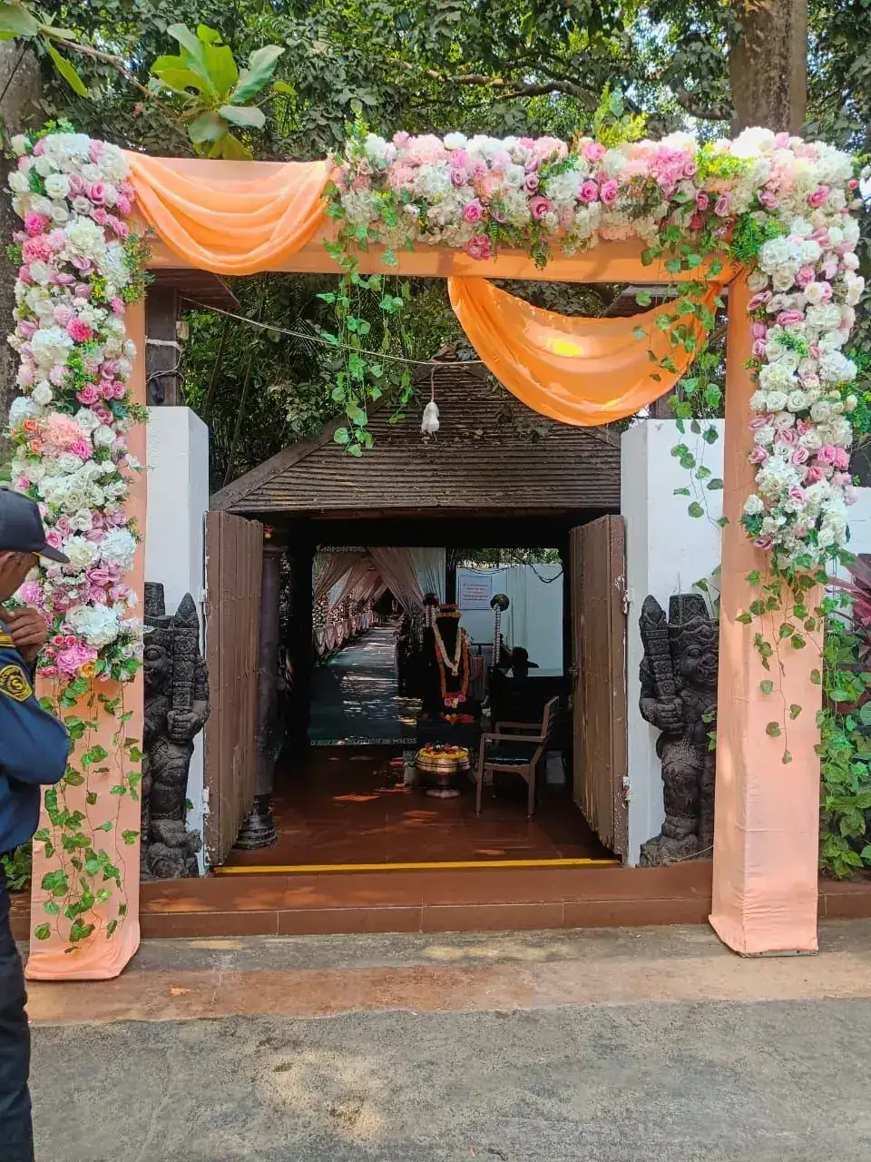 Floral entrance arch with peach drapes at Exotica Tropical Retreat