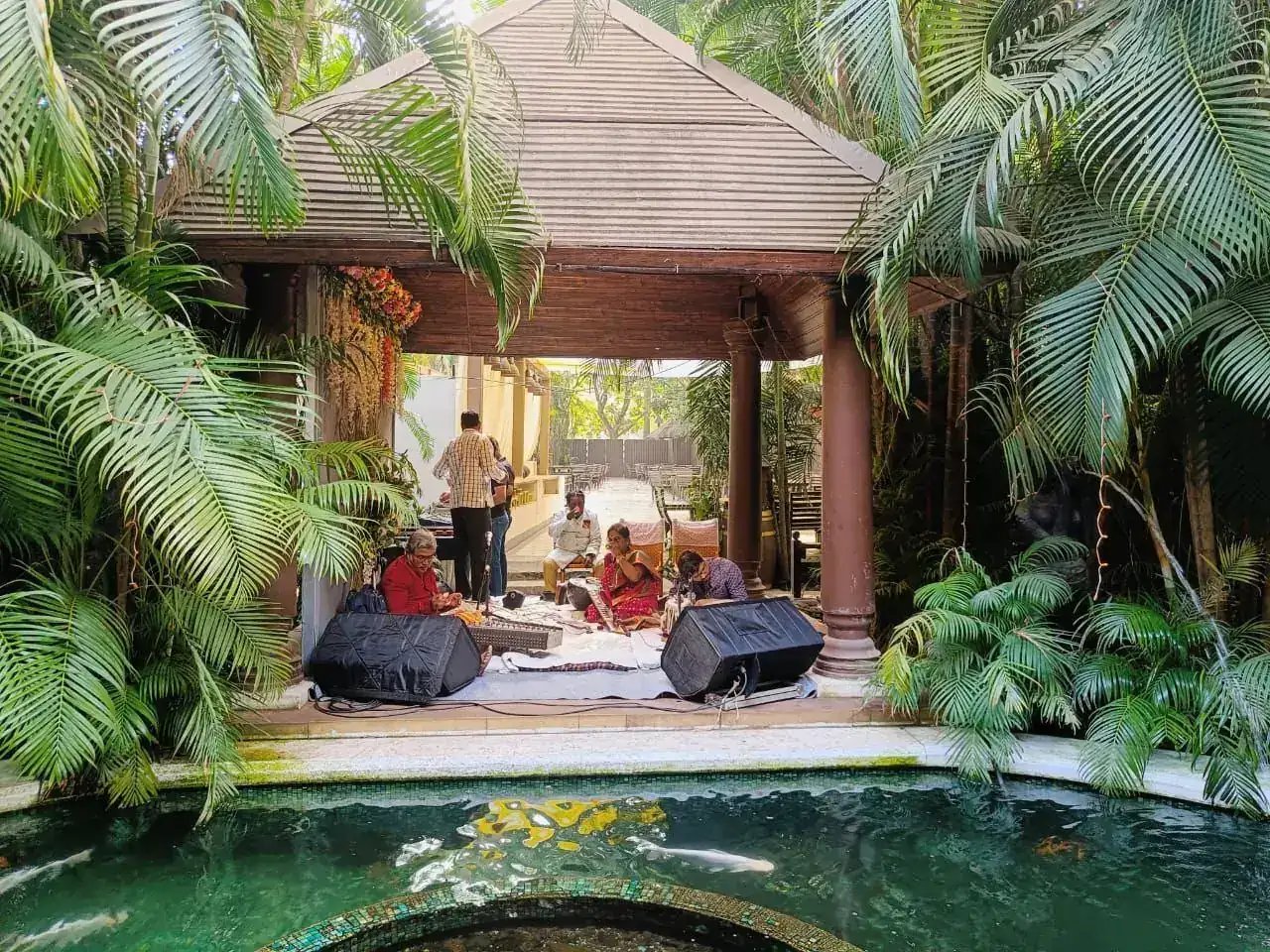 Pond-side gazebo with guests at a wedding ceremony beside the koi pond at Exotica