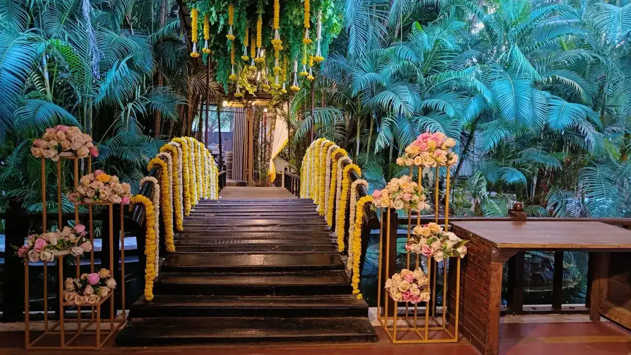 Entrance steps decorated with marigold garlands and floral stands at Exotica