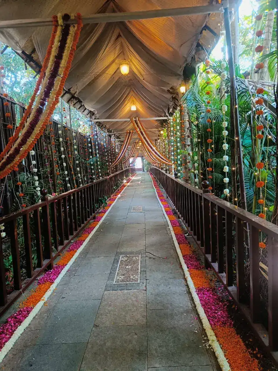 Decorated walkway with hanging garlands and lanterns at Exotica Tropical Retreat