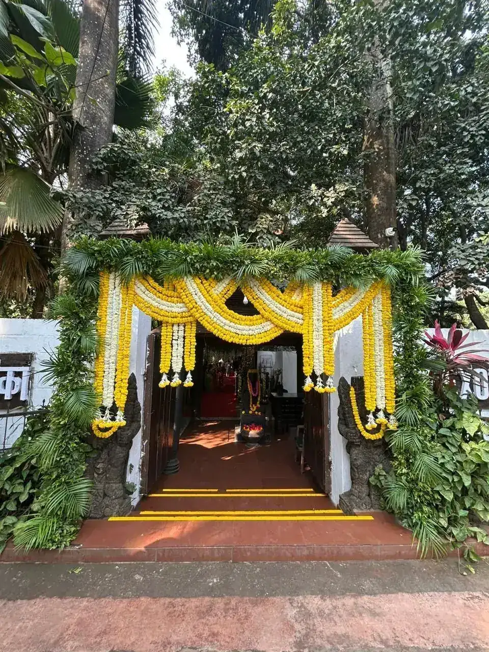 Marigold-decorated entrance archway at Exotica Tropical Retreat, Yeoor Hills
