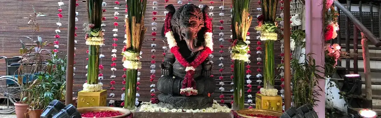 Ganesha idol adorned with floral garlands at the Exotica venue entrance