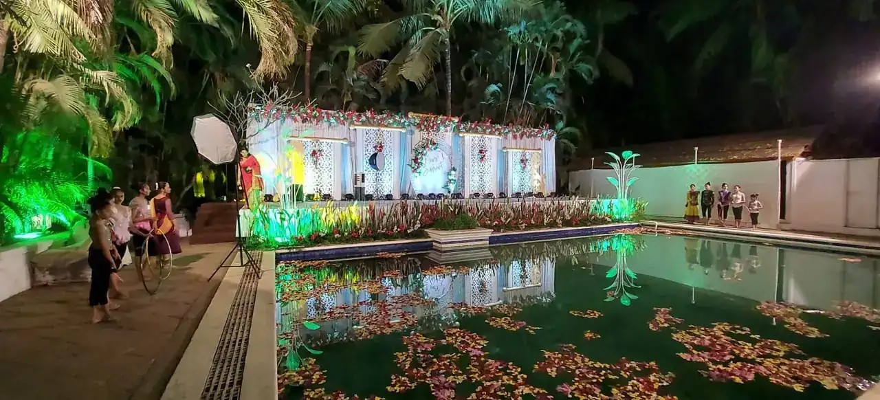 Evening poolside reception with petals on the water at Exotica