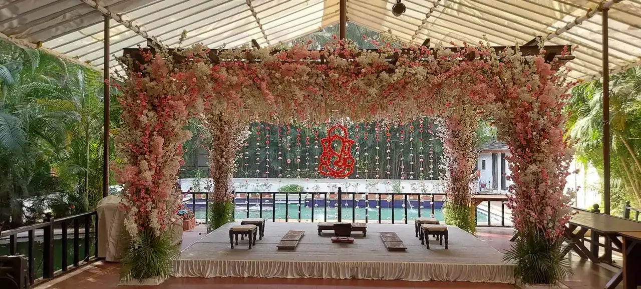 Pavilion stage decorated with pink flowers for a sangeet at Exotica